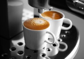 close shot of mr. coffee espresso and cappuccino maker pouring coffee on cups