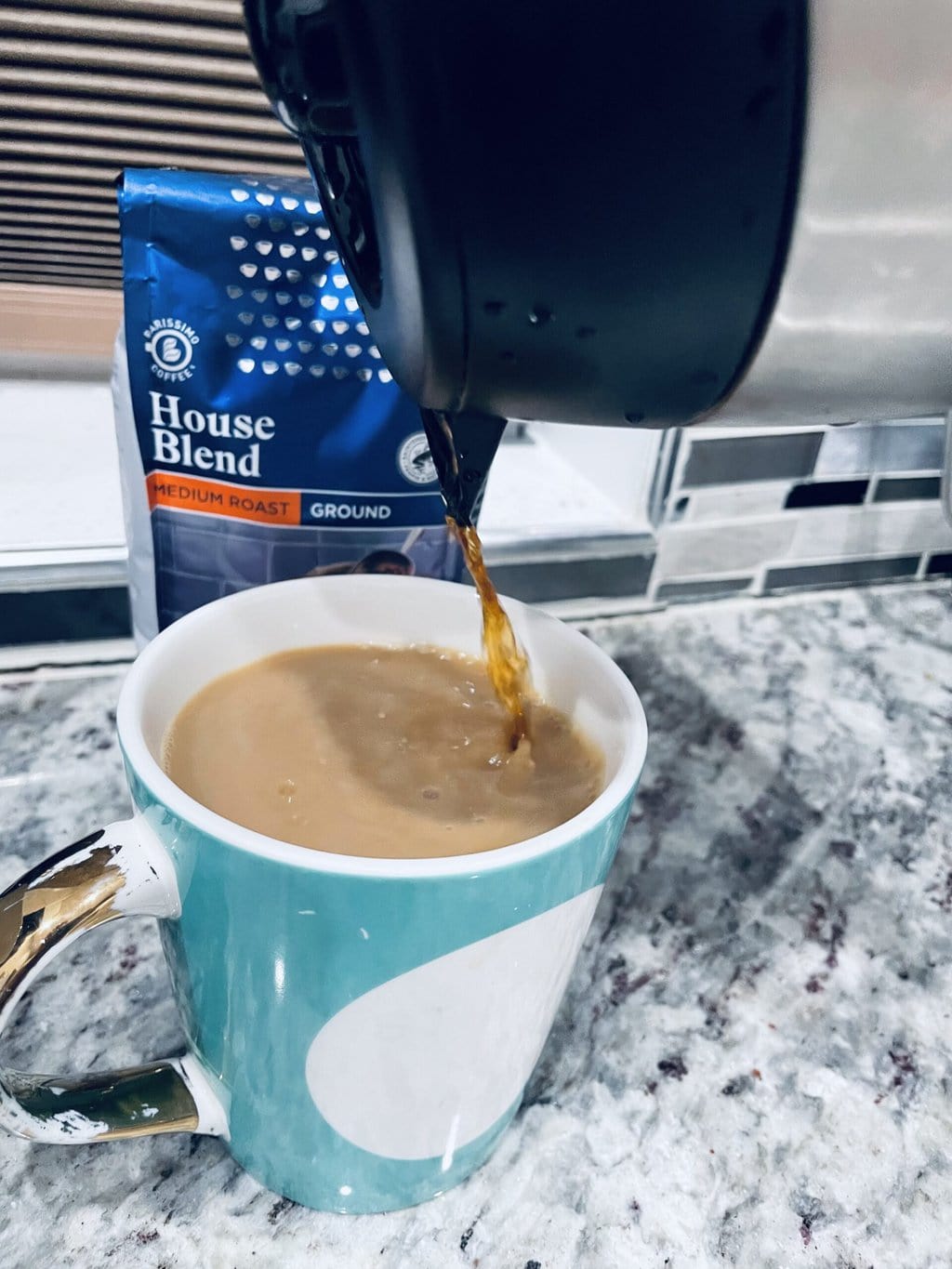 pouring brewed coffee into the cup